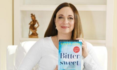 Photo of Susan Cain holding copy of Bittersweet